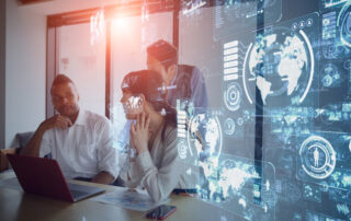 A team of employees sitting in a boardroom studying different analytics