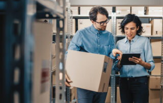 Female inventory manager using Salesforce inventory management in a warehouse.