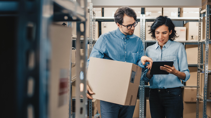 Female inventory manager using Salesforce inventory management in a warehouse.