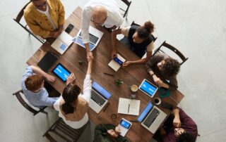 Business meeting to discuss the positive impact Salesforce knowledge management has had on revenue and customer experience.